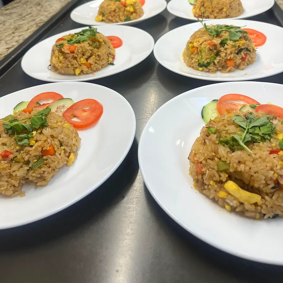 A full line of plated vegetable fried rice dishes — Bay Area catering volume plating by Coach Cal
